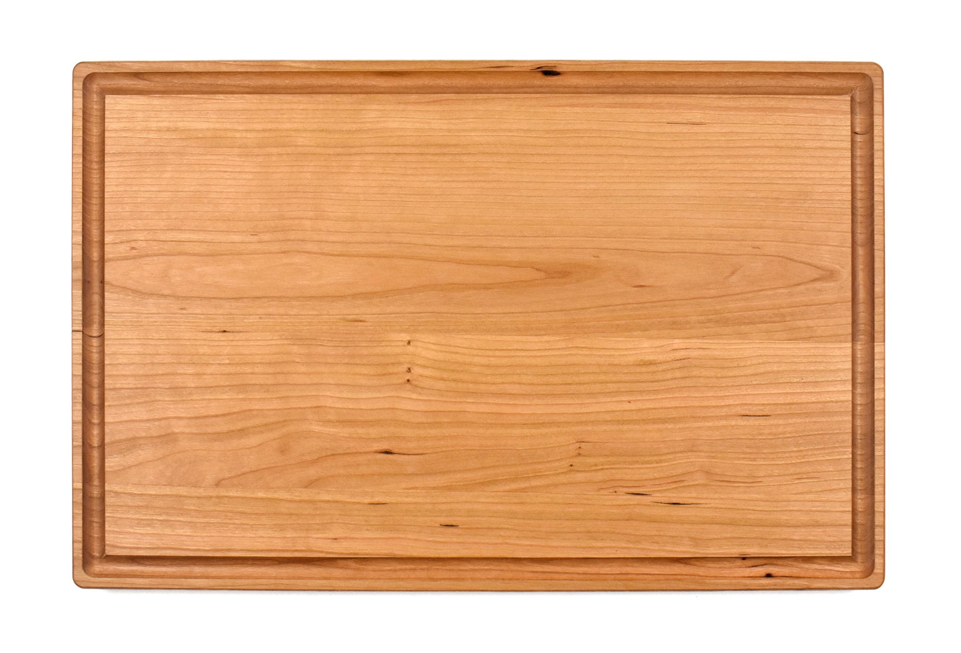 Edge grain cutting board made of cherry.&nbsp; Reversible design with juice groove on one side.