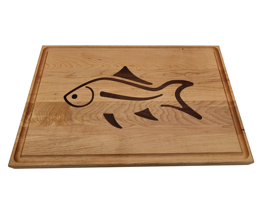 Fish inlay edge grain cutting board. Made of hard maple with walnut inlay. Reversible design with juice groove on one side.